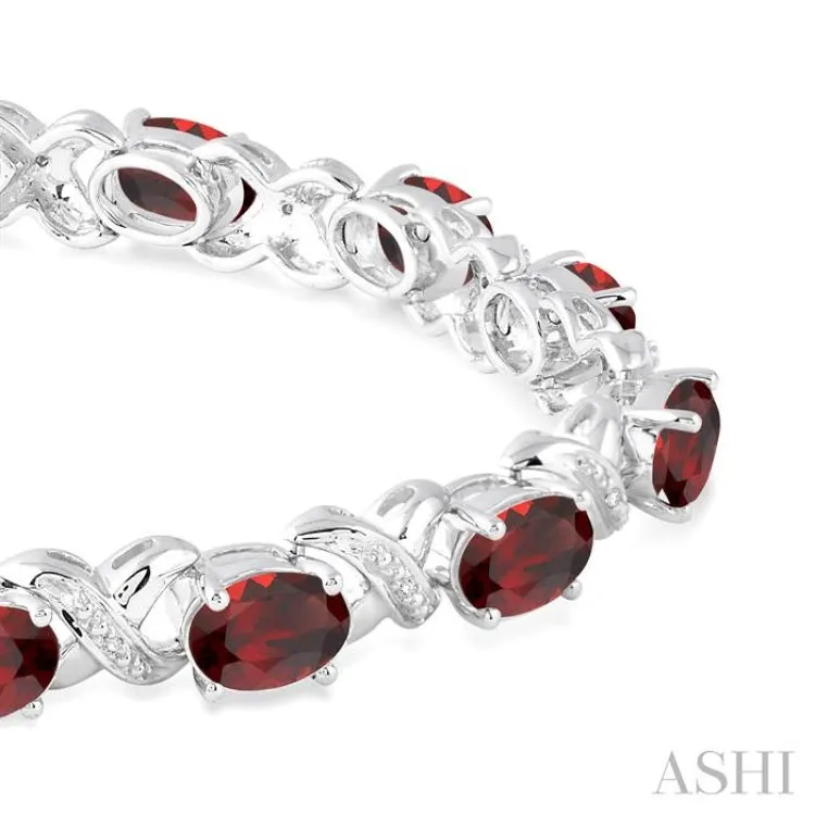 7x5 mm Oval Cut Garnet and 1/20 Ctw Round Cut Diamond Fashion Bracelet in Sterling Silver