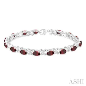 7x5 mm Oval Cut Garnet and 1/20 Ctw Round Cut Diamond Fashion Bracelet in Sterling Silver