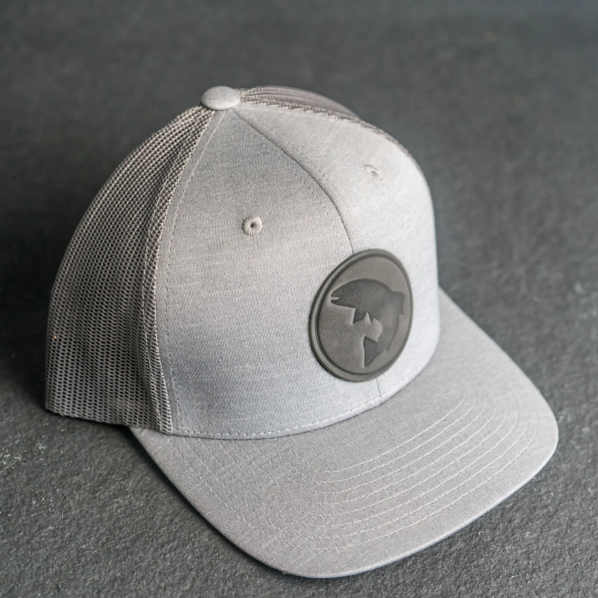 Leather Patch Performance Style Trucker Hat - Circle Patch - Fish Stamp